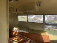 a room in a bus with a couch and a bed