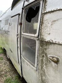 a silver airplane with a broken window