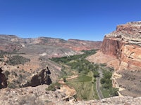 a view of a canyon with a road running through it